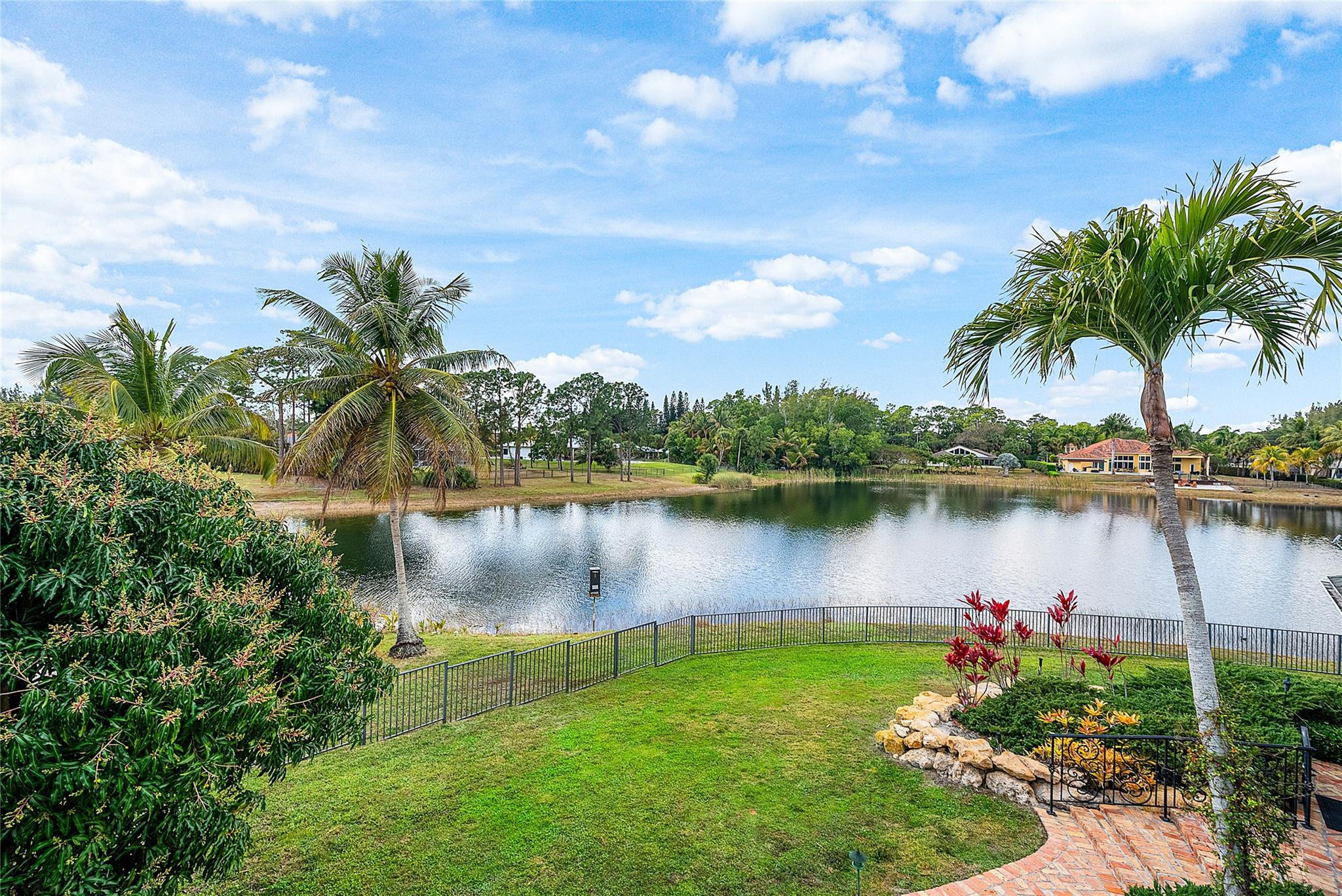 8035 Dillman Road West Palm Beach, FL 33411 - Photo 40 of 70 a lake with palm trees in the background