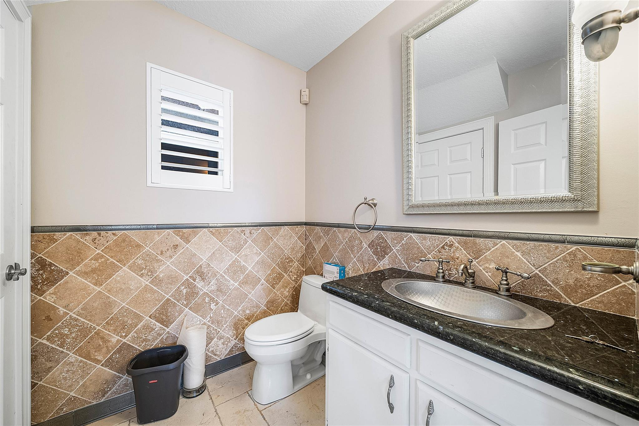 8035 Dillman Road West Palm Beach, FL 33411 - Photo 49 of 70 a bathroom with a granite countertop sink and a toilet