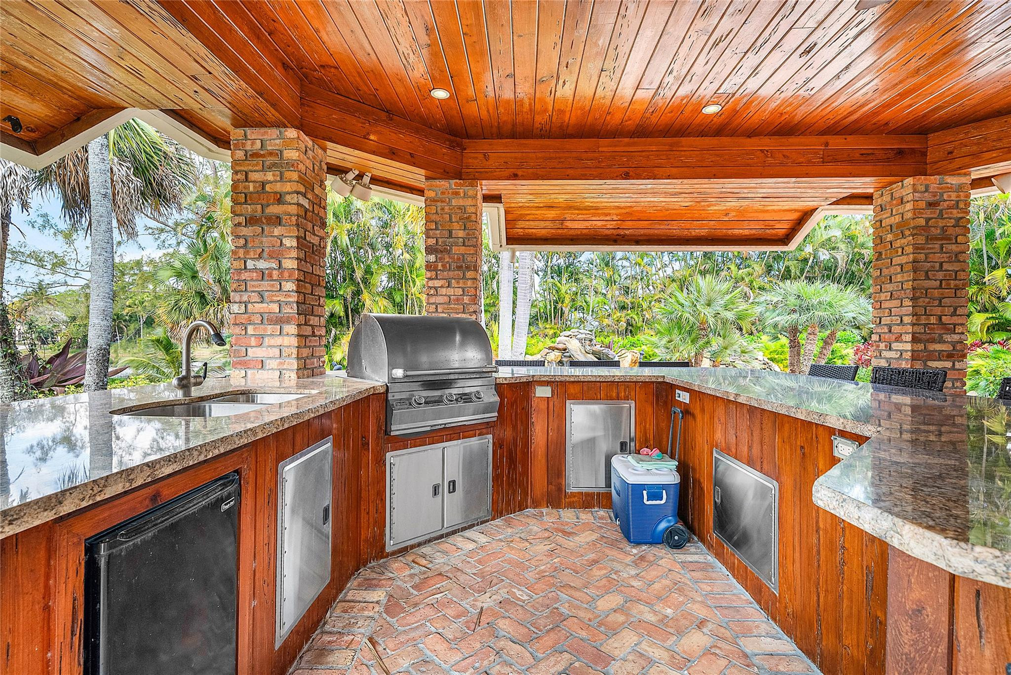 8035 Dillman Road West Palm Beach, FL 33411 - Photo 66 of 70 a kitchen with stainless steel appliances wooden cabinets a sink and a large window