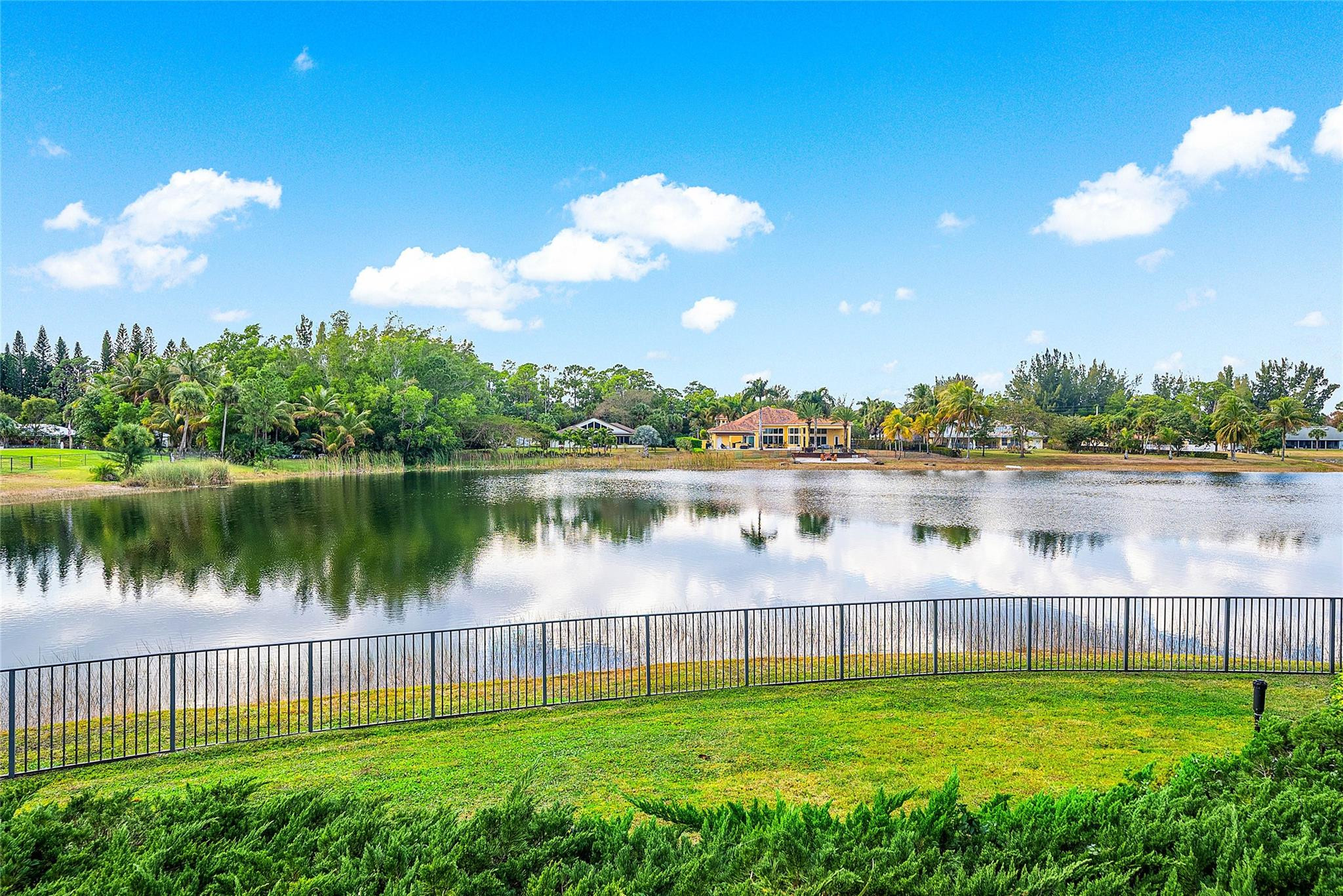 8035 Dillman Road West Palm Beach, FL 33411 - Photo 68 of 70 a view of a lake with a big yard and large trees