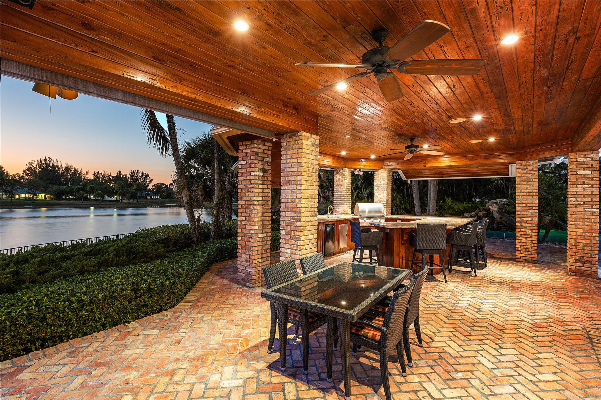8035 Dillman Road West Palm Beach, FL 33411 - Photo 8 of 70 a view of a patio with table and chairs a barbeque with wooden floor and fence