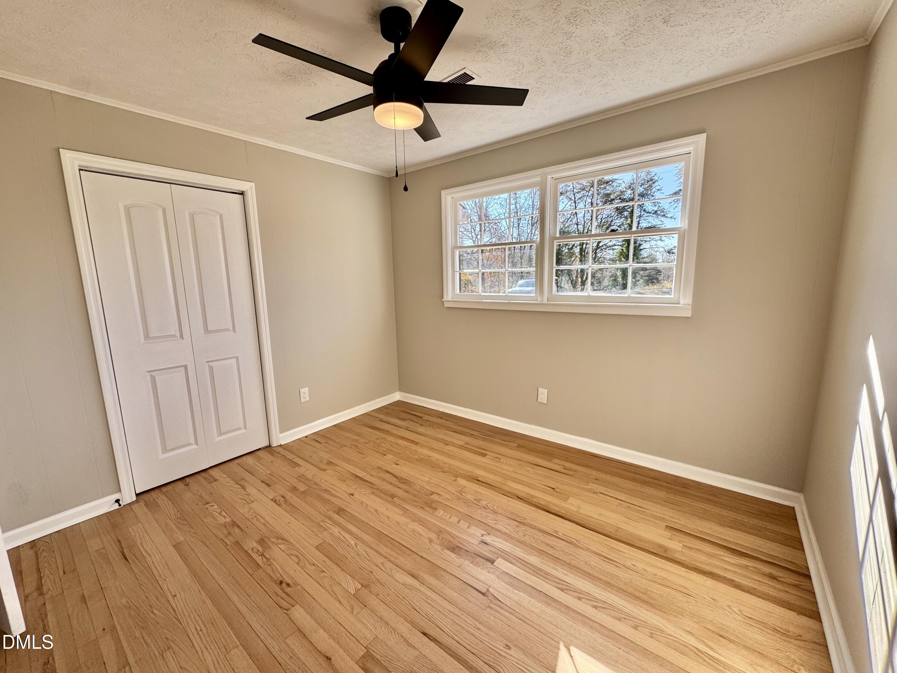727 High Rock School Road Blanch, NC 27212 - Photo 14 of 29 wooden floor in an empty room with a window