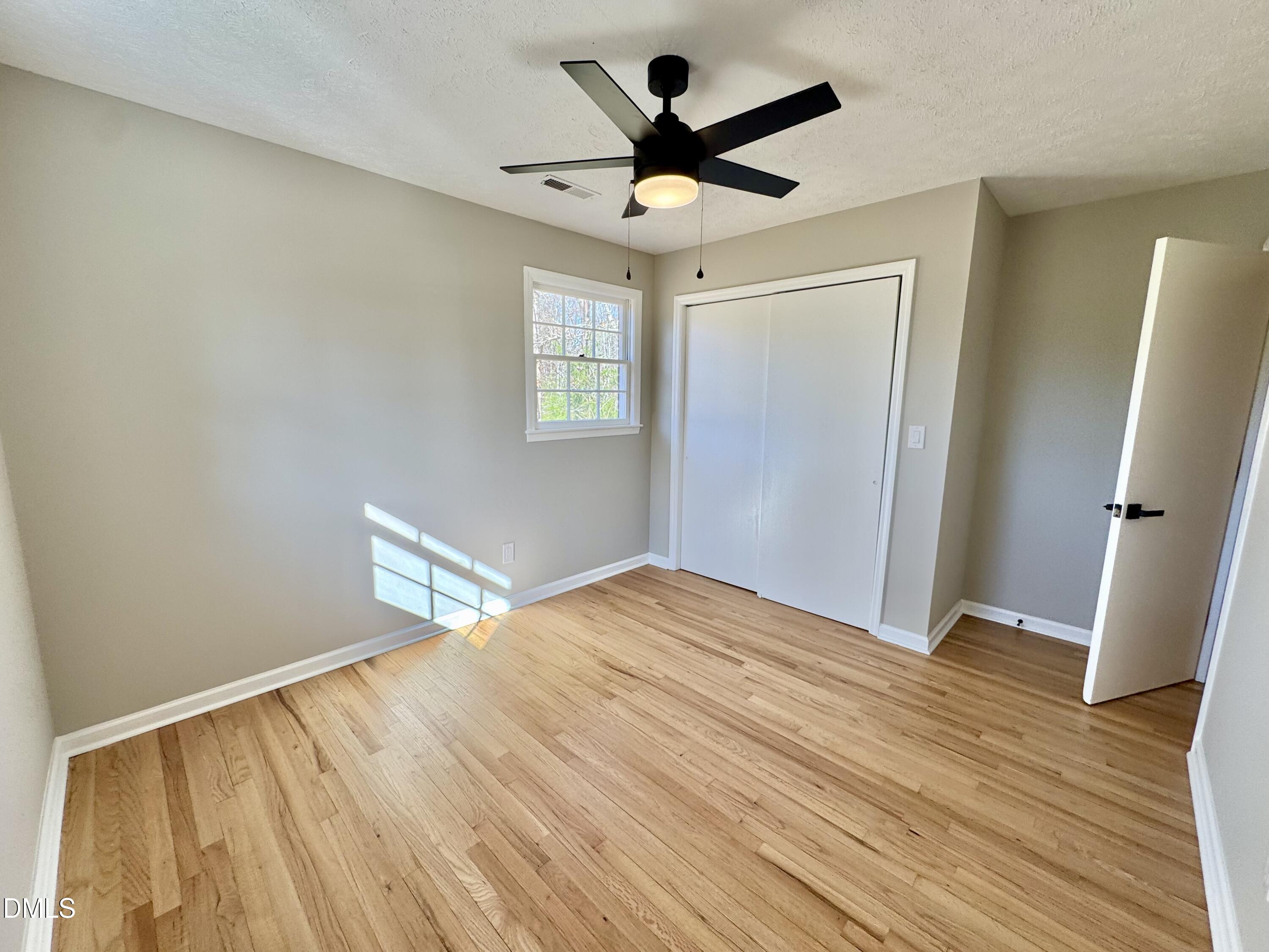 727 High Rock School Road Blanch, NC 27212 - Photo 20 of 29 a view of a livingroom with wooden floor and a ceiling fan