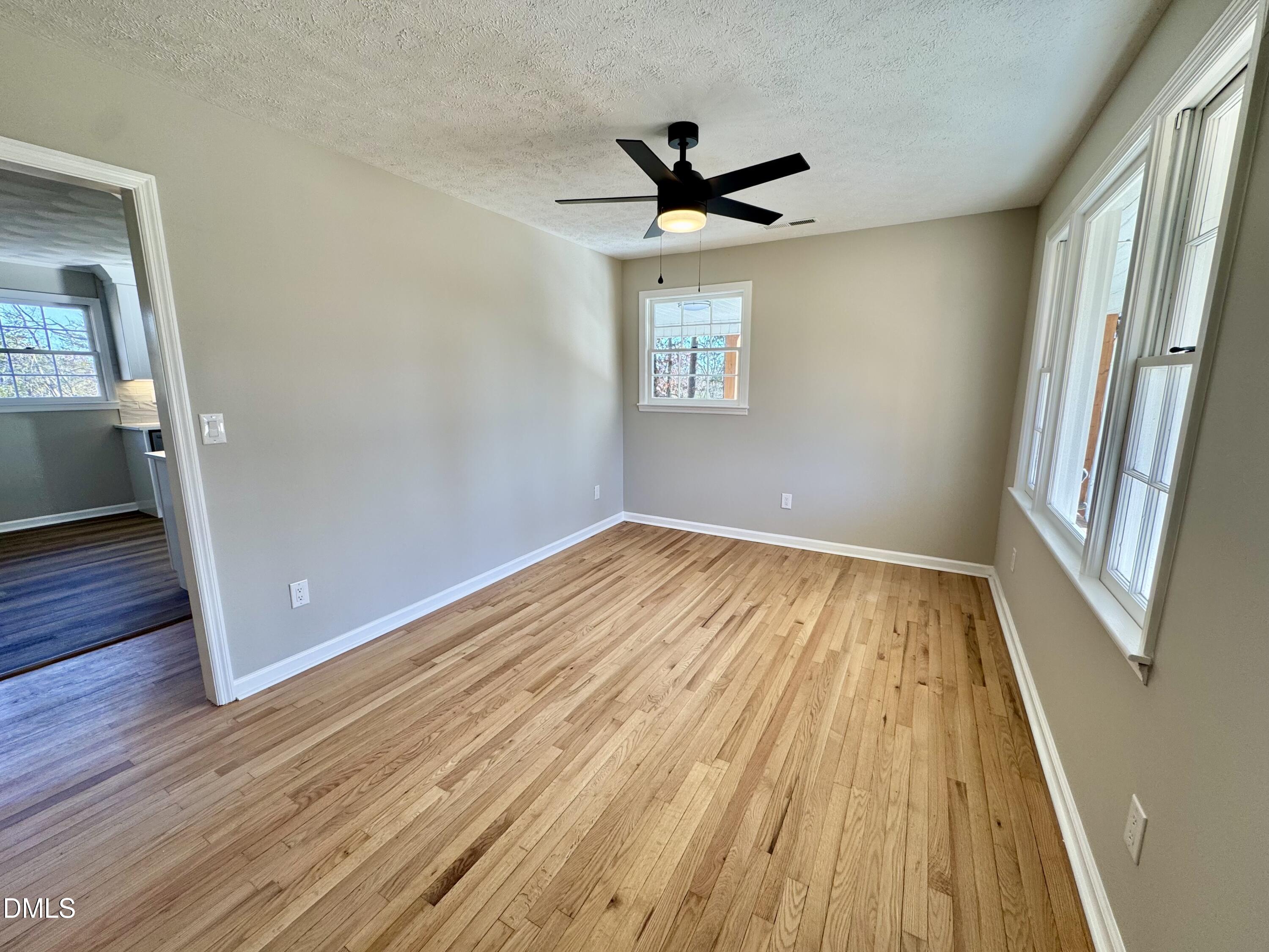 727 High Rock School Road Blanch, NC 27212 - Photo 2 of 29 wooden floor in an empty room with a window