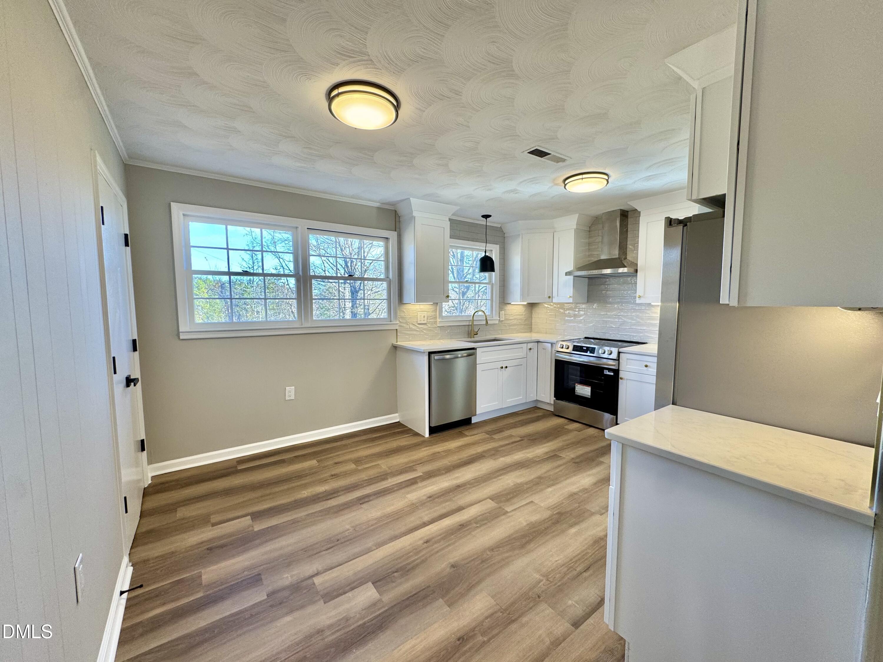 727 High Rock School Road Blanch, NC 27212 - Photo 4 of 29 a view of an empty room with window and cabinet