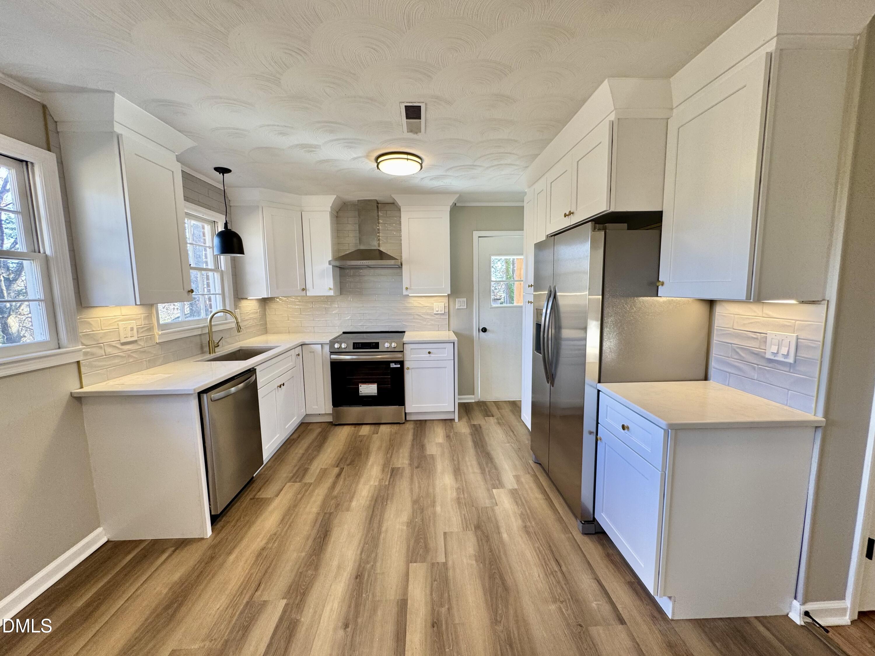 727 High Rock School Road Blanch, NC 27212 - Photo 5 of 29 a large kitchen with a sink a counter top space stainless steel appliances and cabinets