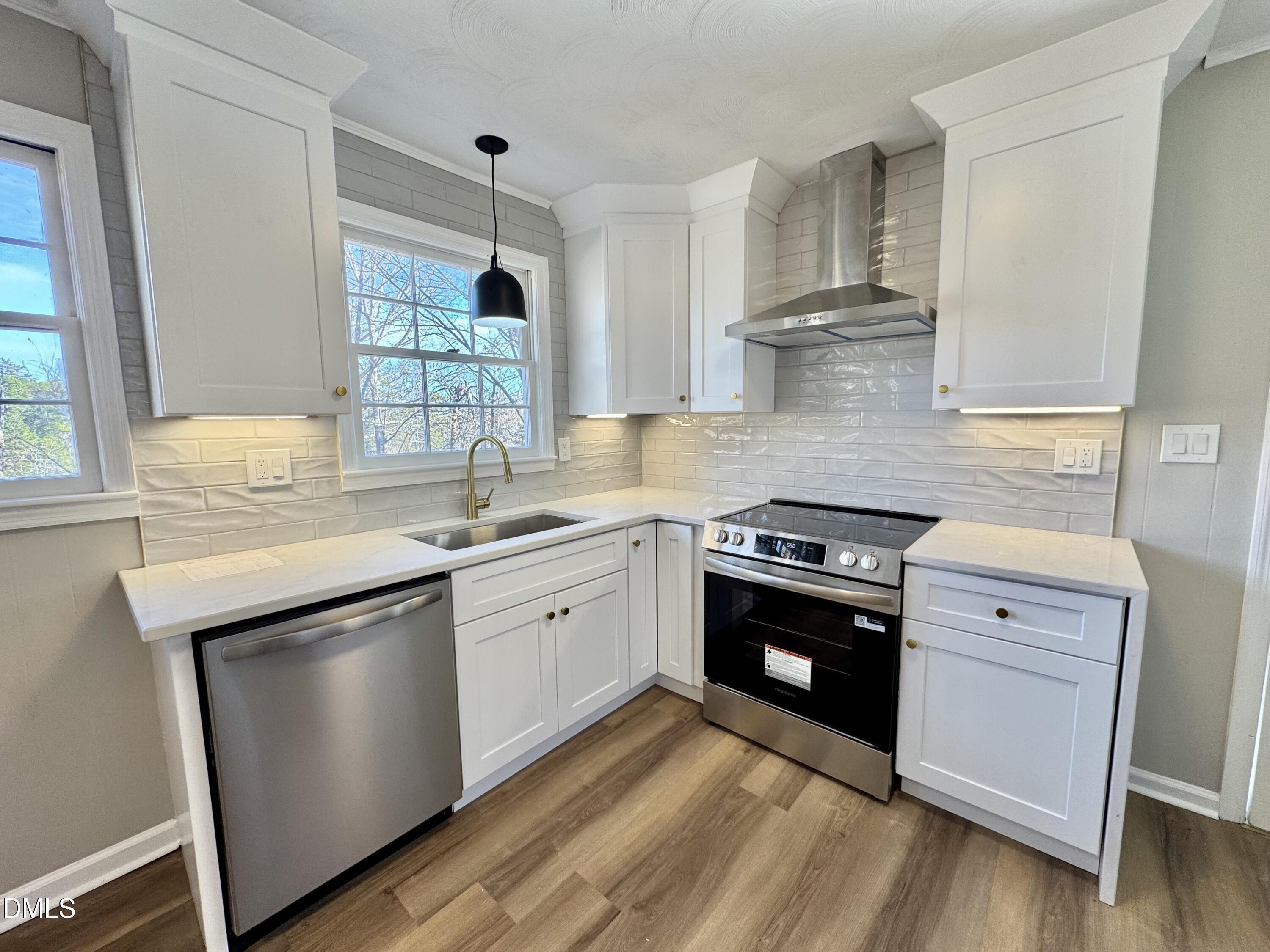 727 High Rock School Road Blanch, NC 27212 - Photo 6 of 29 a kitchen with stainless steel appliances granite countertop a sink a stove and a window