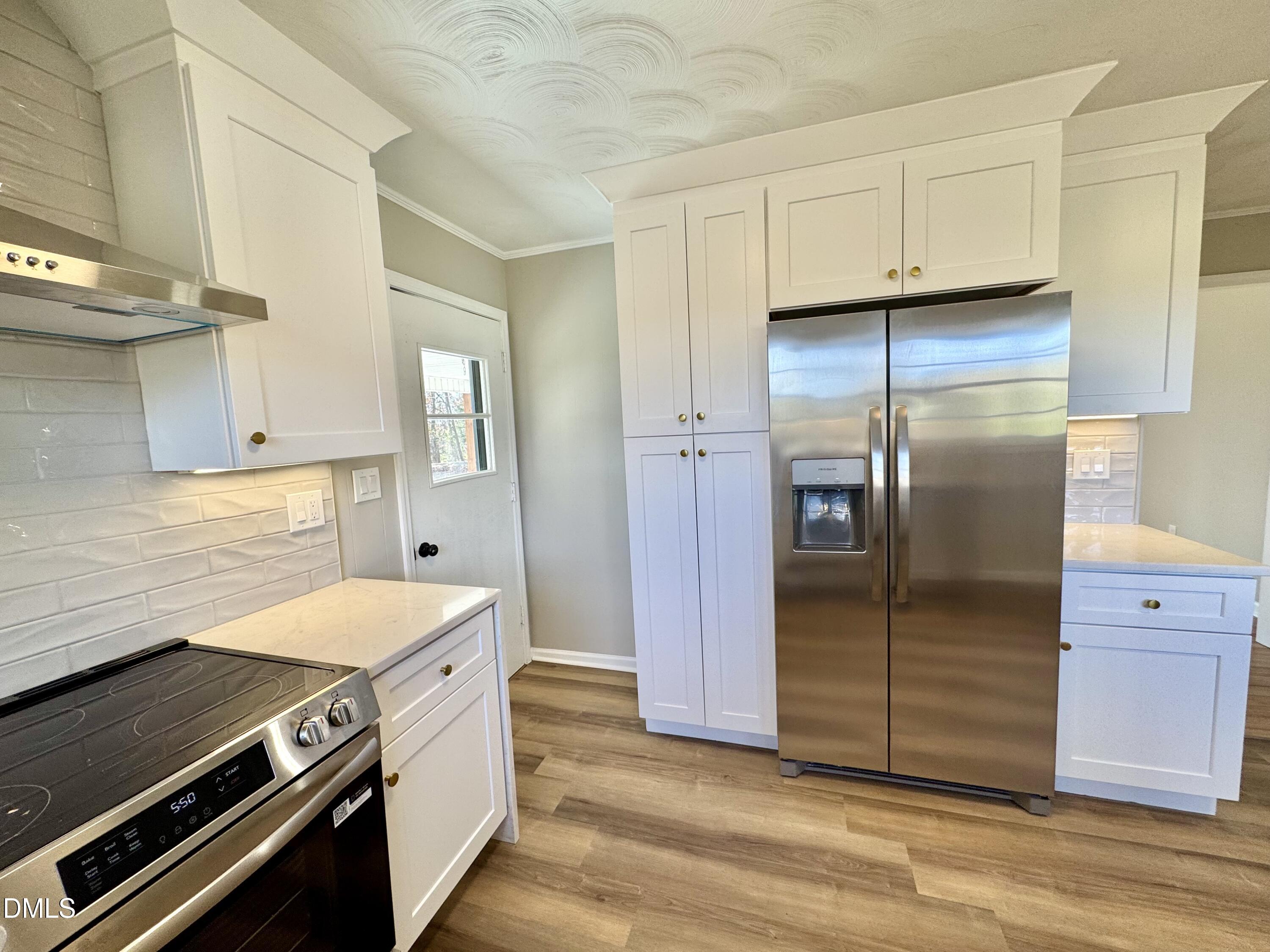 727 High Rock School Road Blanch, NC 27212 - Photo 8 of 29 a kitchen with a refrigerator stove and cabinets