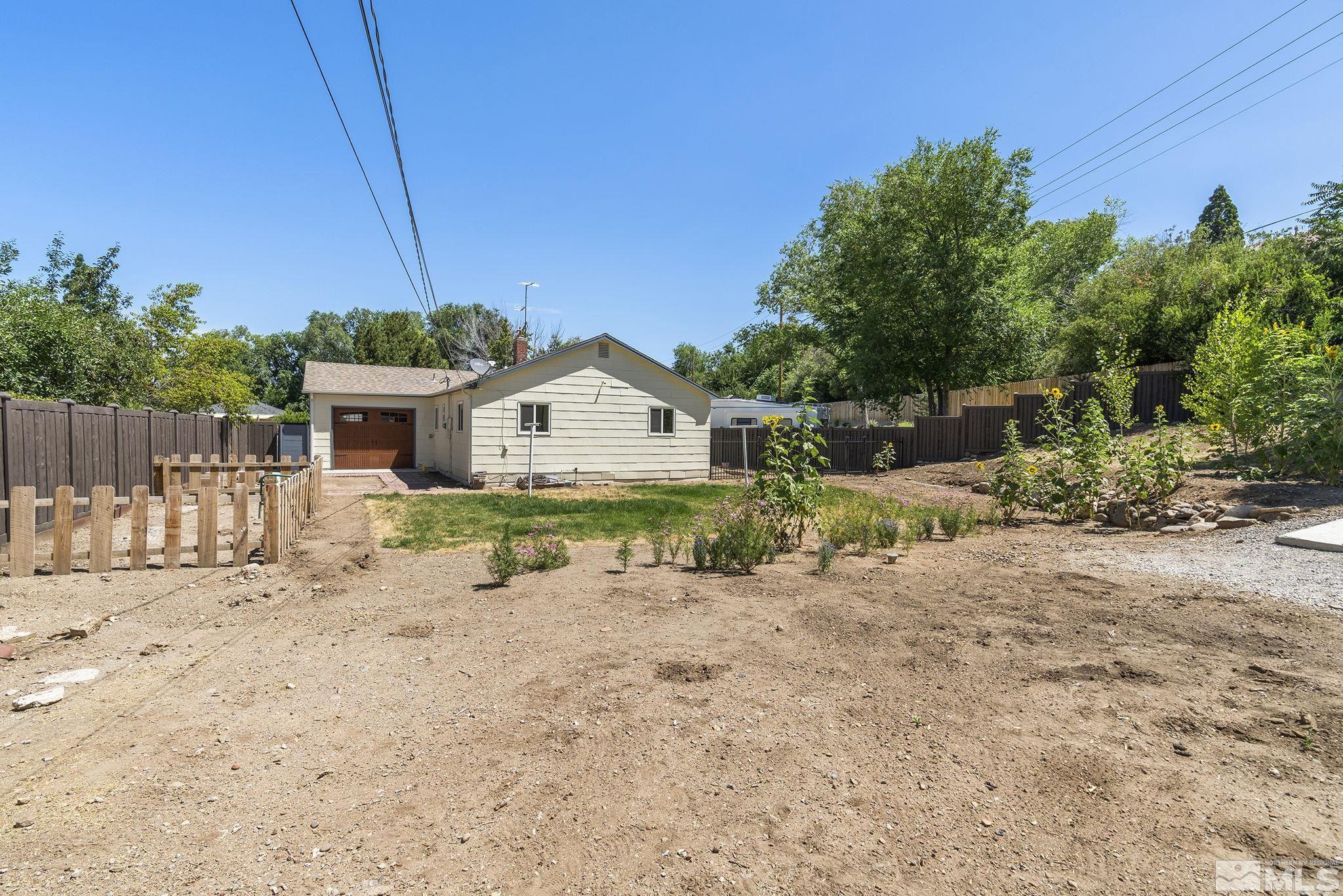 50 Kaye Way Reno, NV 89509 - Photo 13 of 16 a front view of a house with a yard and garage