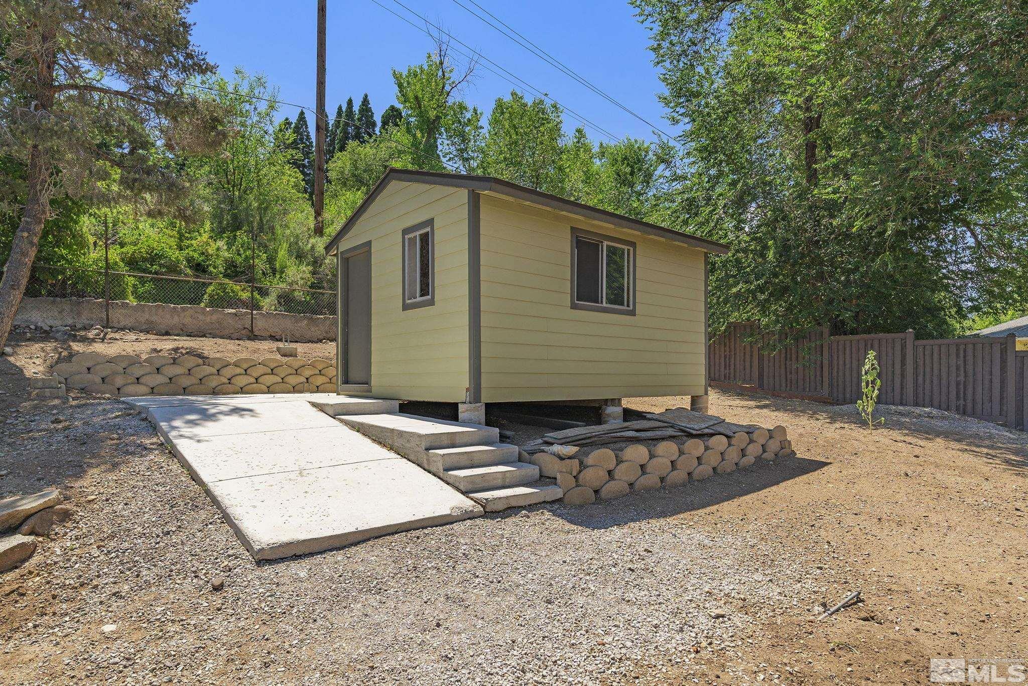 50 Kaye Way Reno, NV 89509 - Photo 14 of 16 a backyard of a house with barbeque oven fire pit table and chairs
