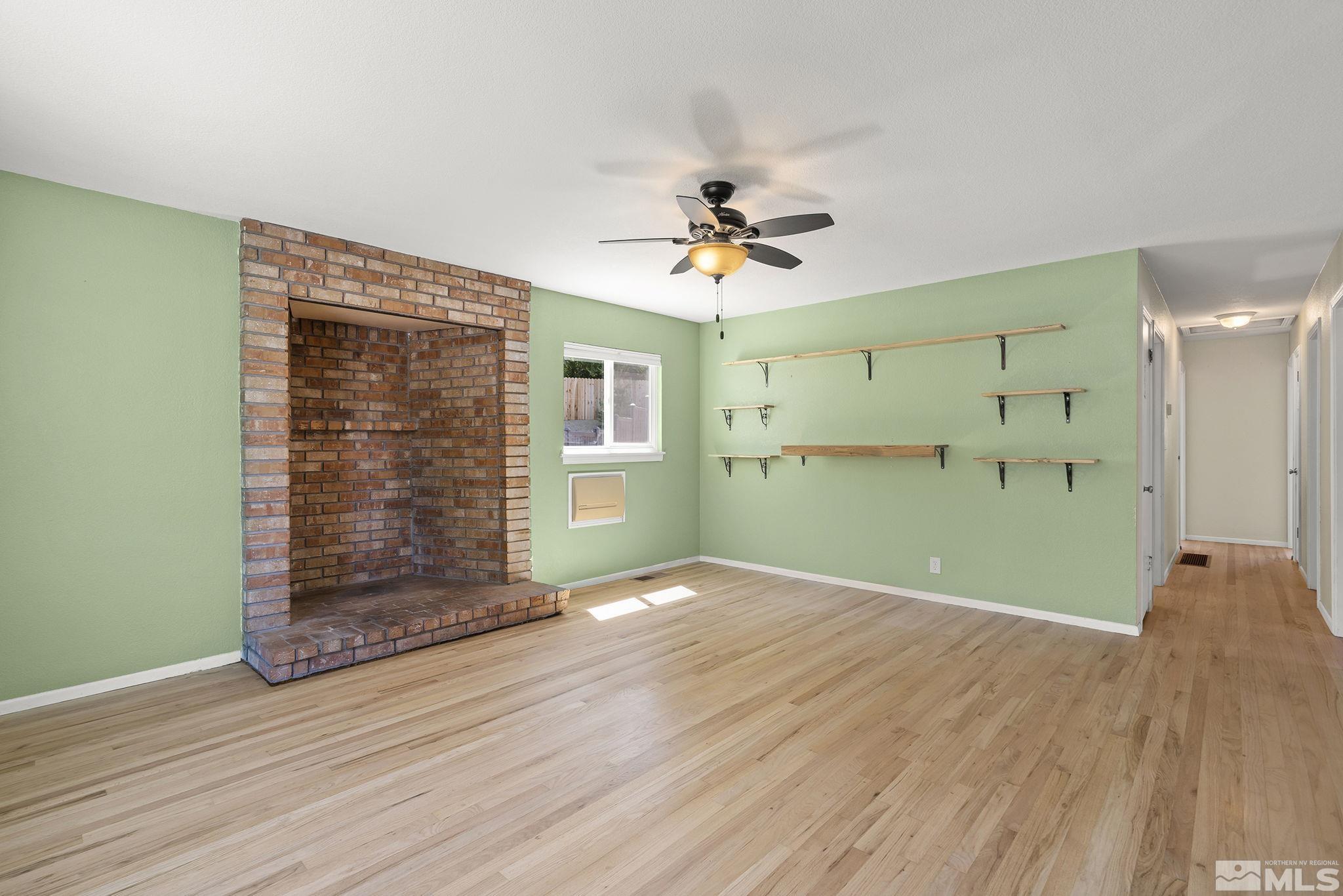 50 Kaye Way Reno, NV 89509 - Photo 3 of 16 a view of empty room with wooden floor and fan