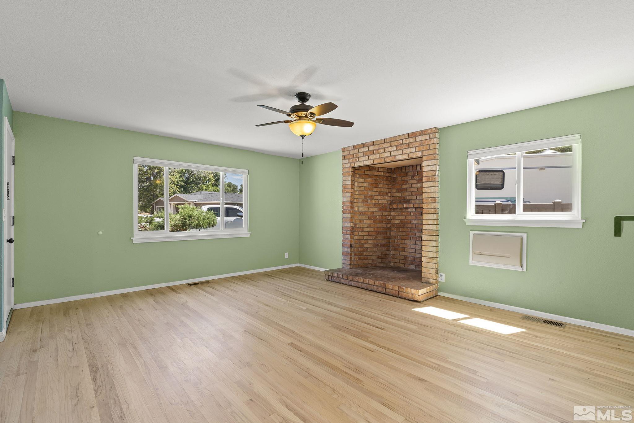 50 Kaye Way Reno, NV 89509 - Photo 5 of 16 a view of an empty room with a window and a fireplace