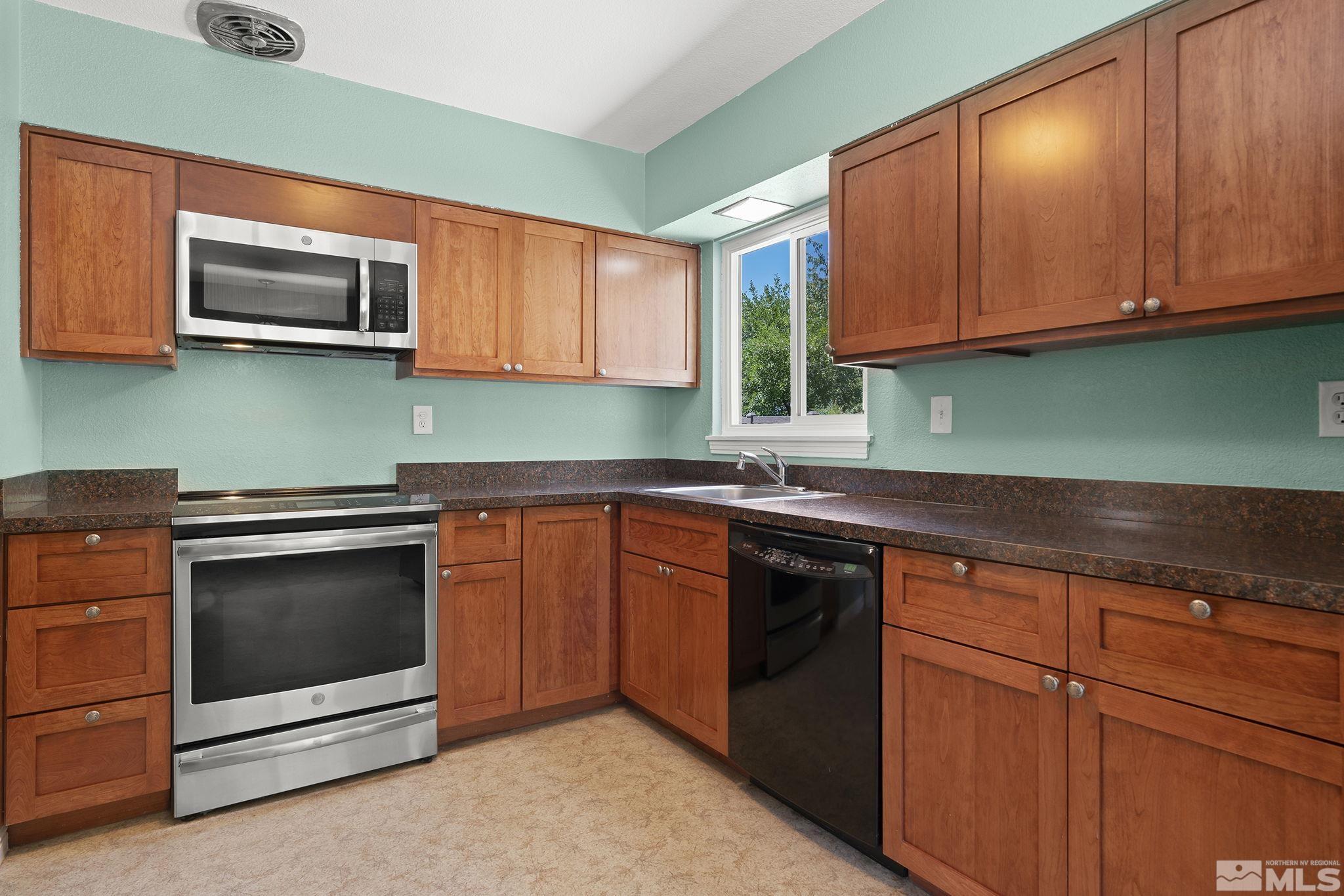 50 Kaye Way Reno, NV 89509 - Photo 6 of 16 a kitchen with stainless steel appliances granite countertop a sink and a microwave
