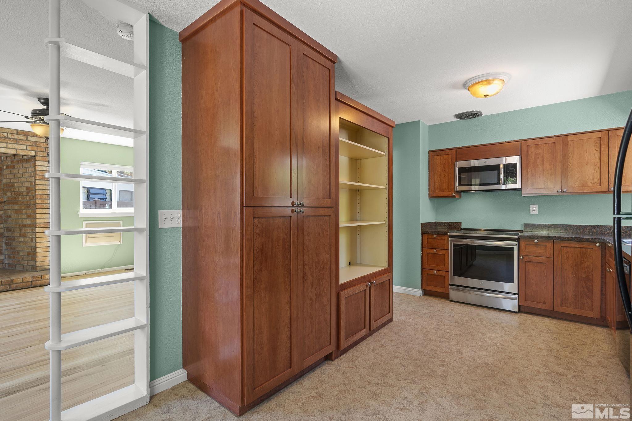 50 Kaye Way Reno, NV 89509 - Photo 7 of 16 a kitchen with stainless steel appliances a stove and a refrigerator