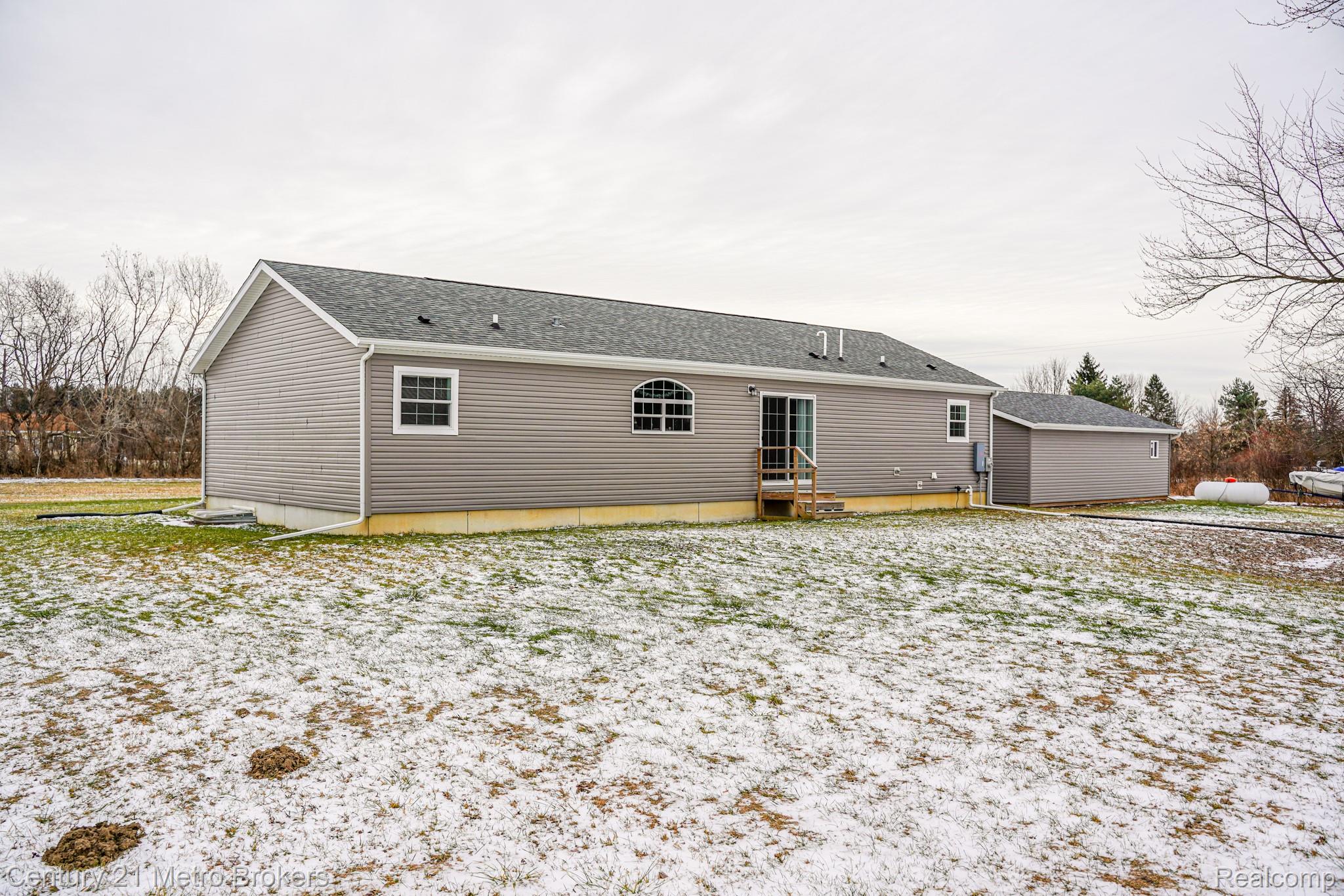 6449 Oliver Road Fostoria, MI 48435 - Photo 17 of 17 Snow covered property with entry steps and roof with shingles