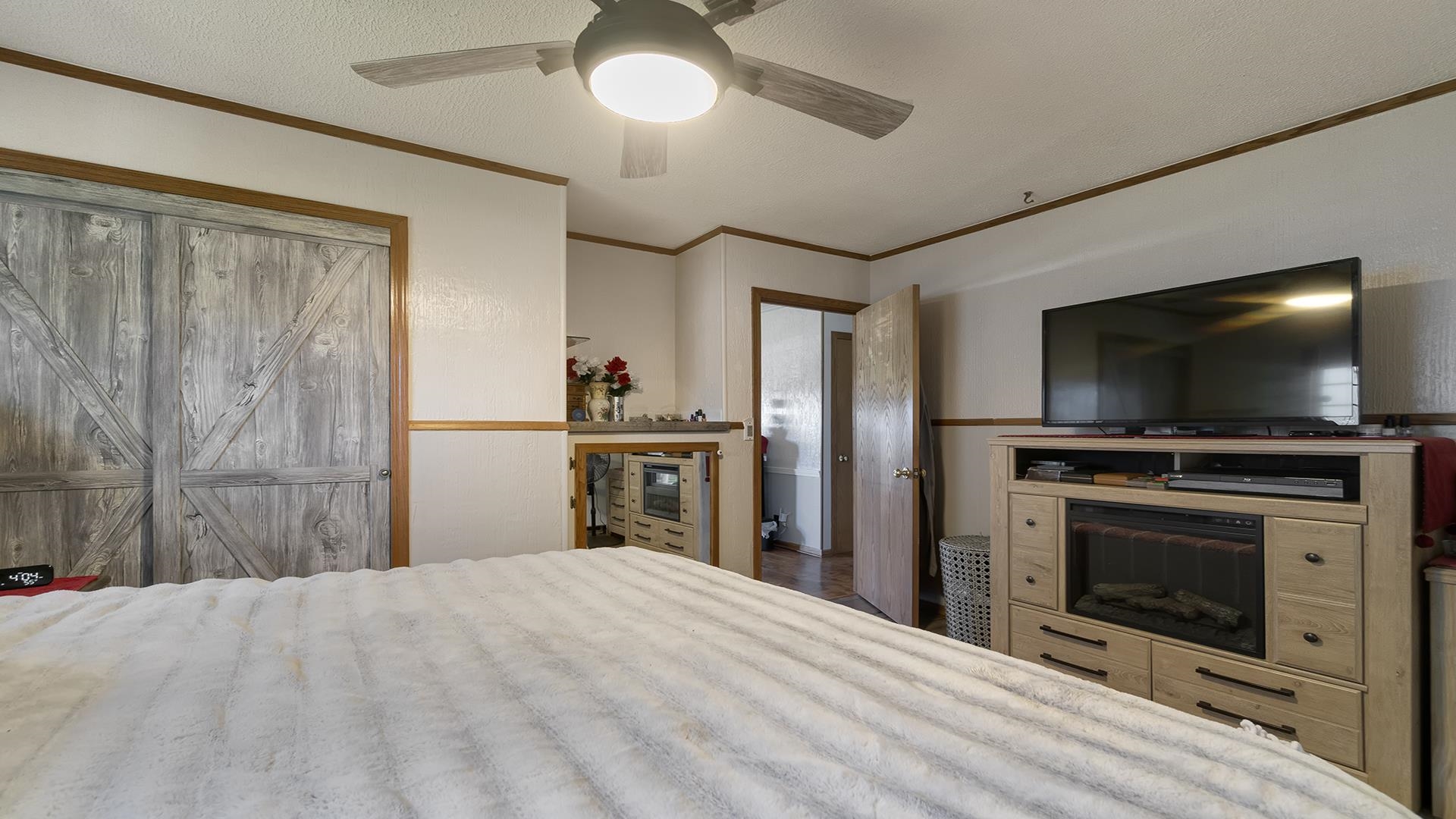 2112 South Alpine Road Rockford, IL 61108 - Photo 19 of 43 a bedroom with a bed and a flat screen tv