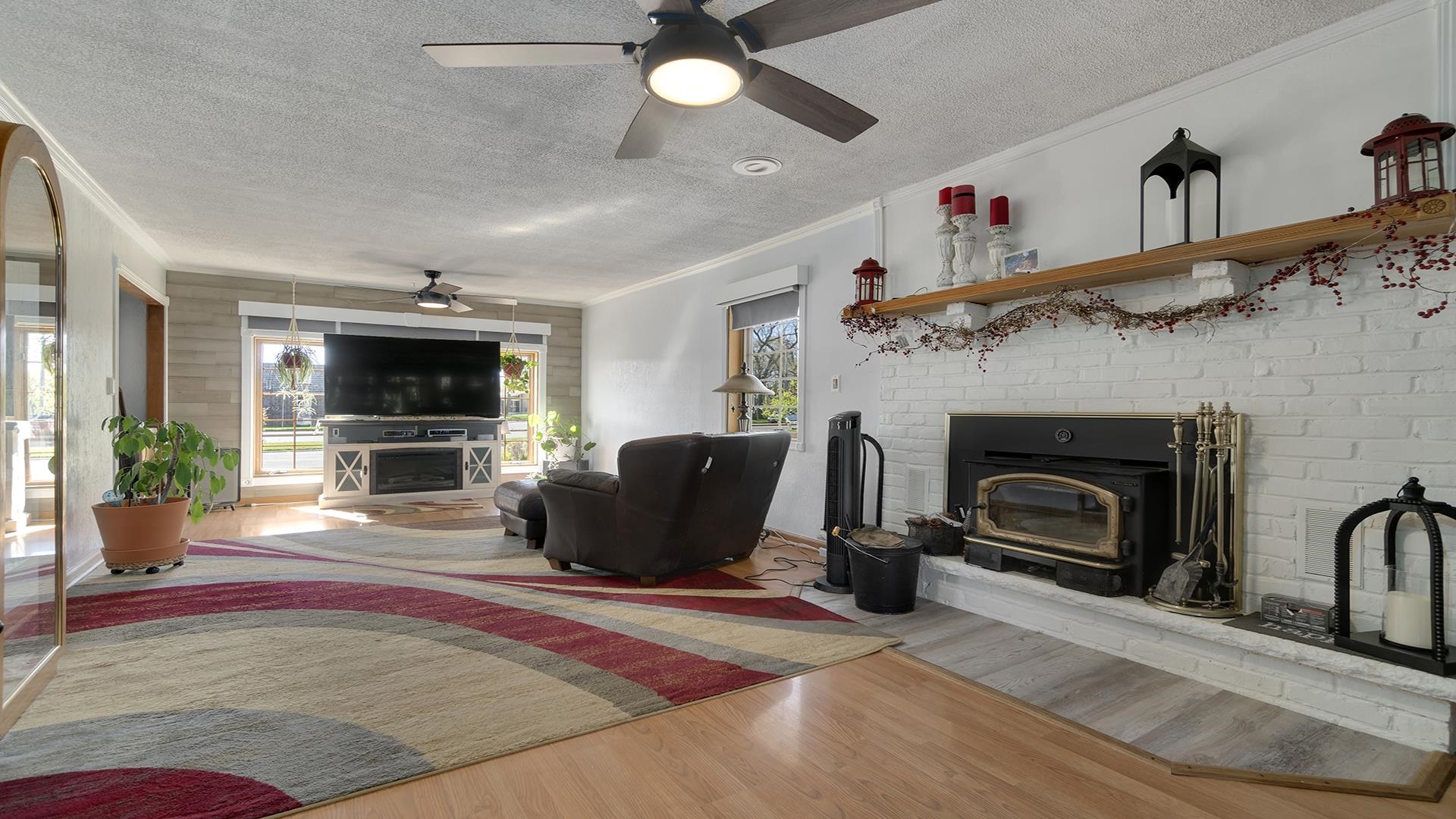 2112 South Alpine Road Rockford, IL 61108 - Photo 9 of 43 a living room with furniture a flat screen tv and a fireplace
