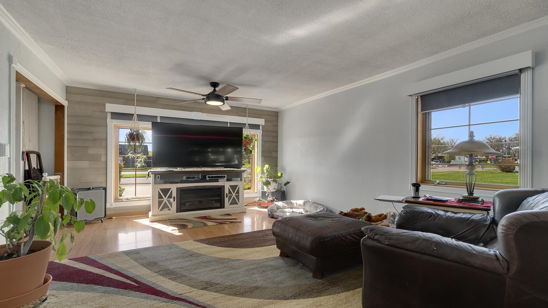 2112 South Alpine Road Rockford, IL 61108 - Photo 10 of 43 a living room with furniture a flat screen tv and a fireplace