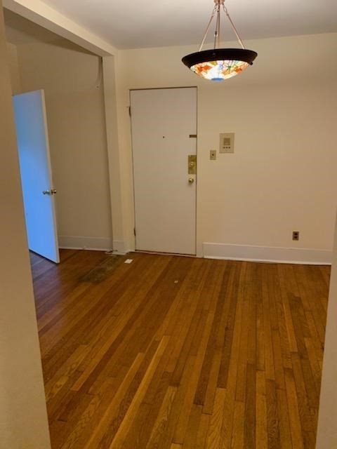 a view of a room with wooden floor and utility room