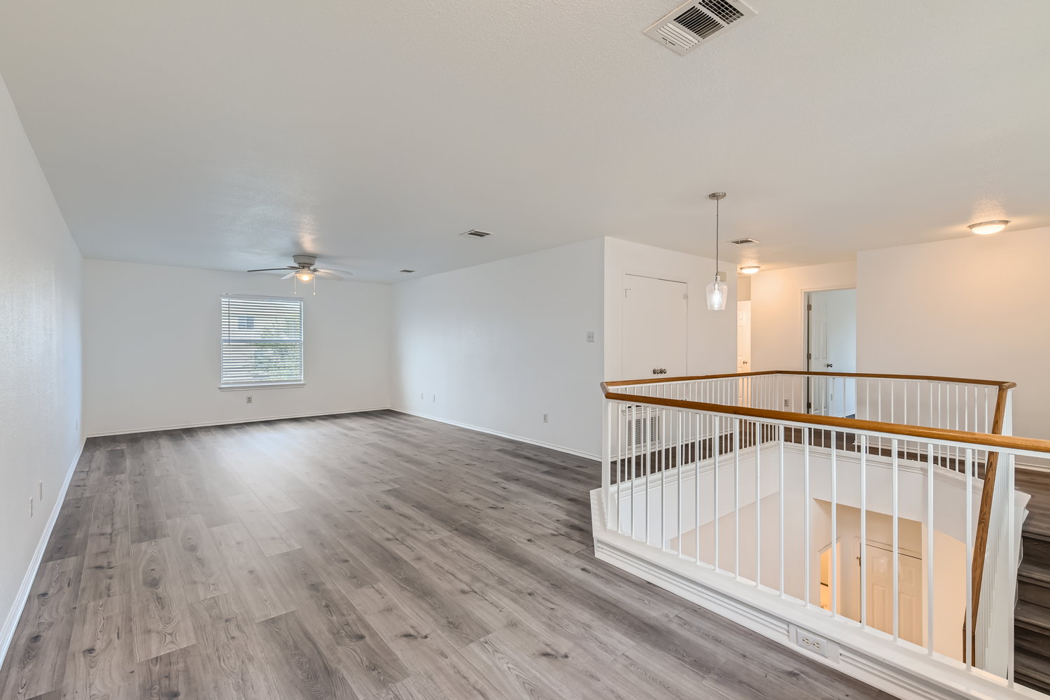 115 Killian Loop Hutto, TX 78634 - Photo 10 of 14 A spacious upper-level living area with sleek flooring, ready for your personalized touch.
