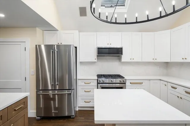 a kitchen with a refrigerator and a sink