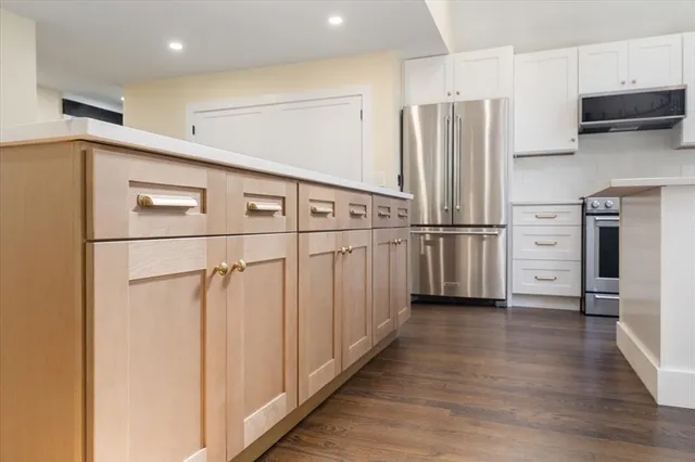 a kitchen with stainless steel appliances refrigerator and cabinets