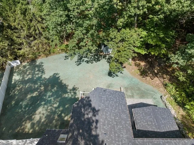 a view of a yard with wooden fence