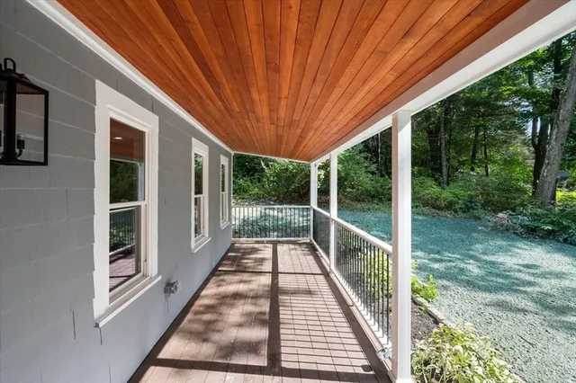 a view of balcony with wooden floor and fence