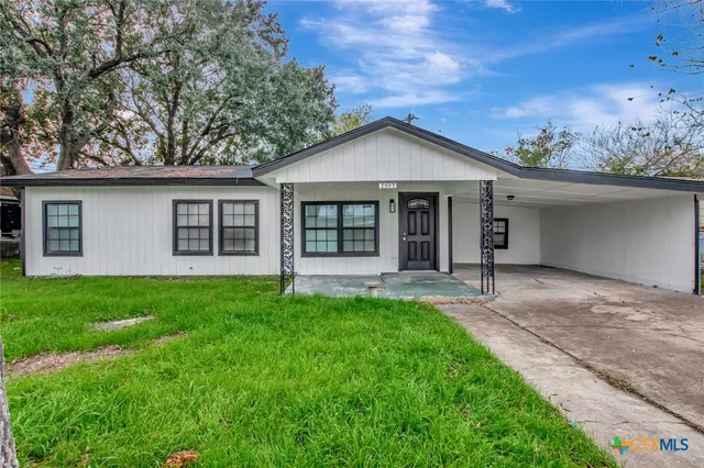 a front view of a house with a yard and porch
