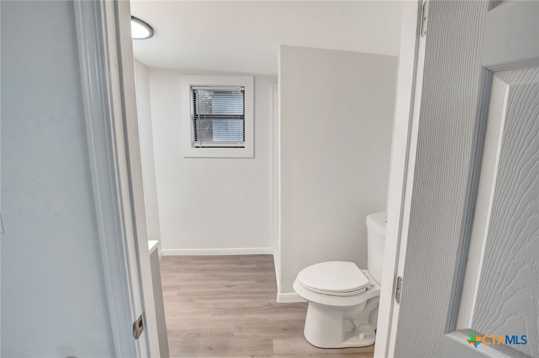 2907 Cedar Street Victoria, TX 77901 - Photo 14 of 45 a white toilet sitting next to a shower