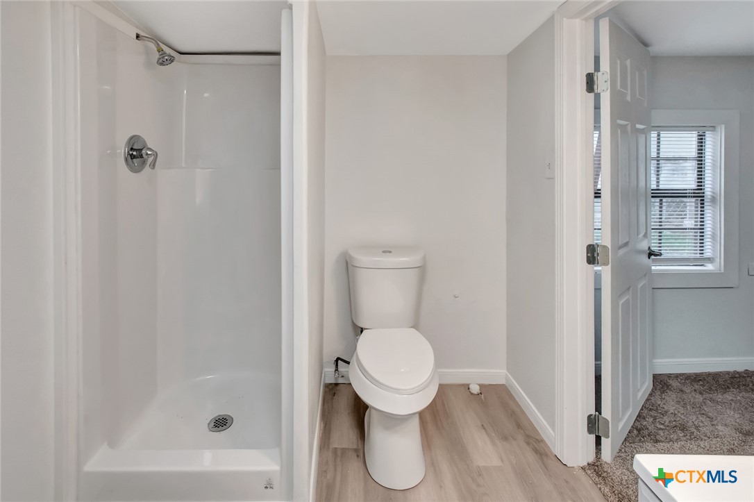 2907 Cedar Street Victoria, TX 77901 - Photo 16 of 45 a bathroom with a toilet and a shower