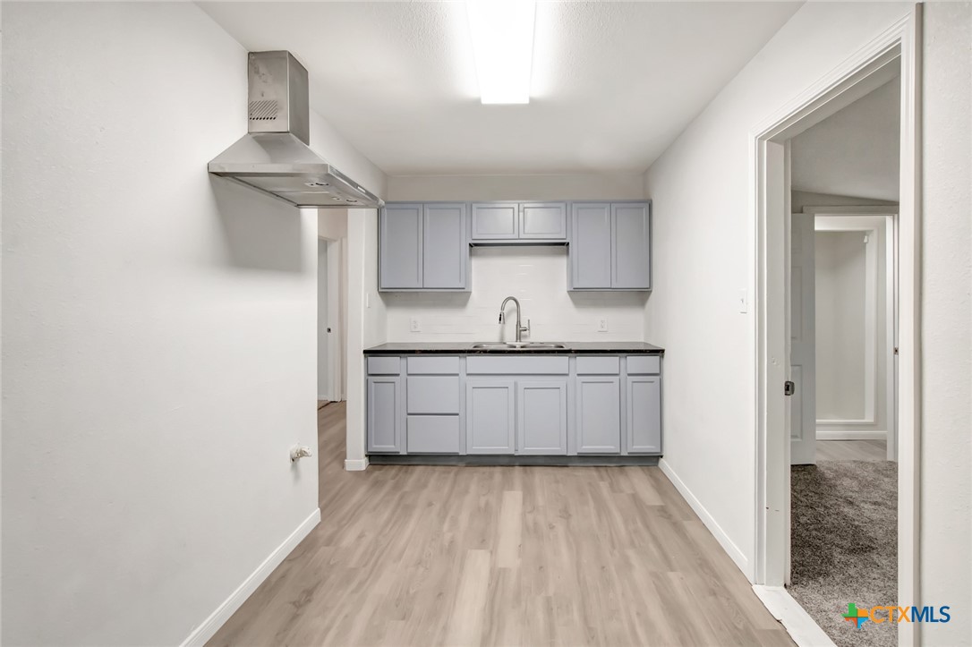2907 Cedar Street Victoria, TX 77901 - Photo 17 of 45 a kitchen with a sink window and cabinets