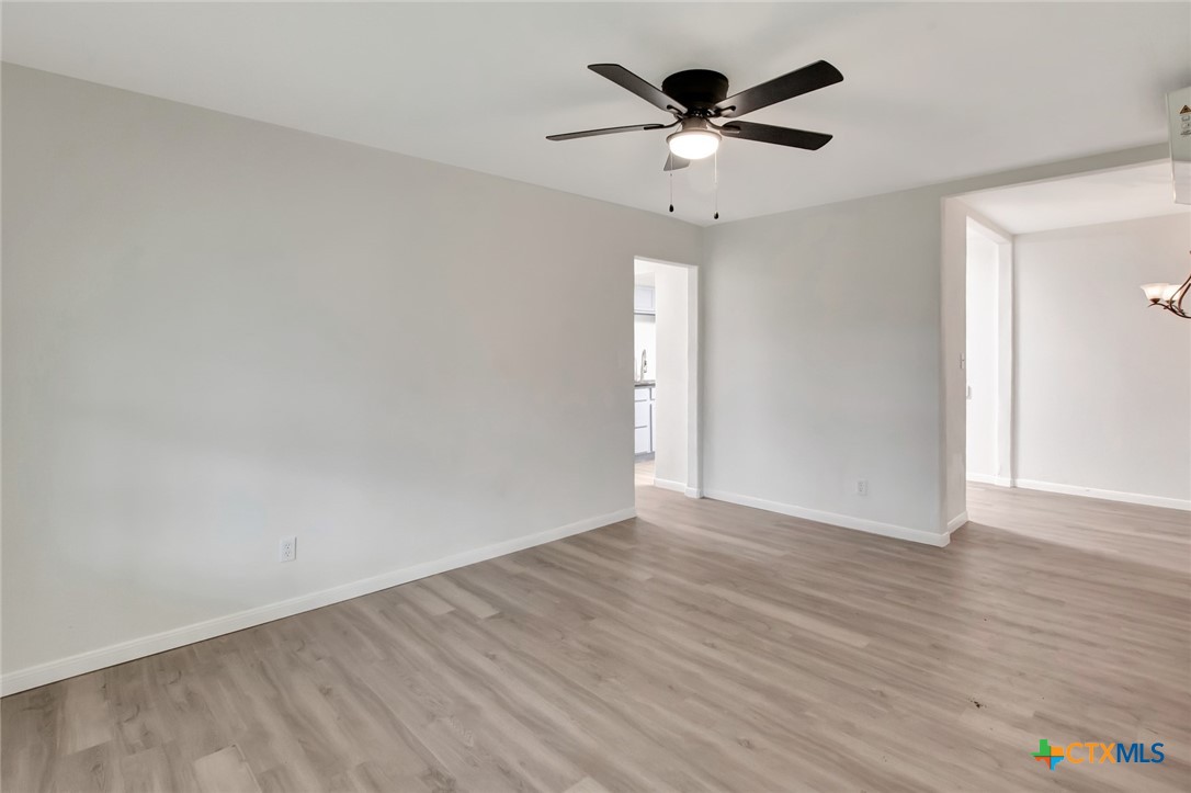 2907 Cedar Street Victoria, TX 77901 - Photo 2 of 45 an empty room with wooden floor and ceiling fan