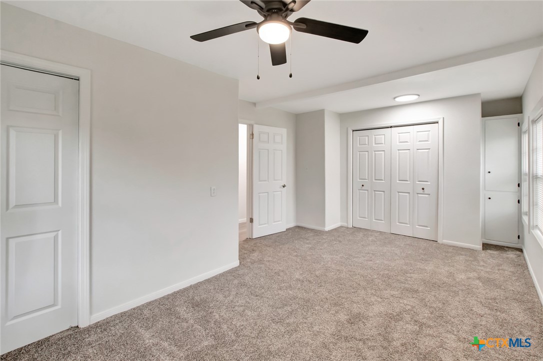 2907 Cedar Street Victoria, TX 77901 - Photo 34 of 45 an empty room with chandelier fan and windows