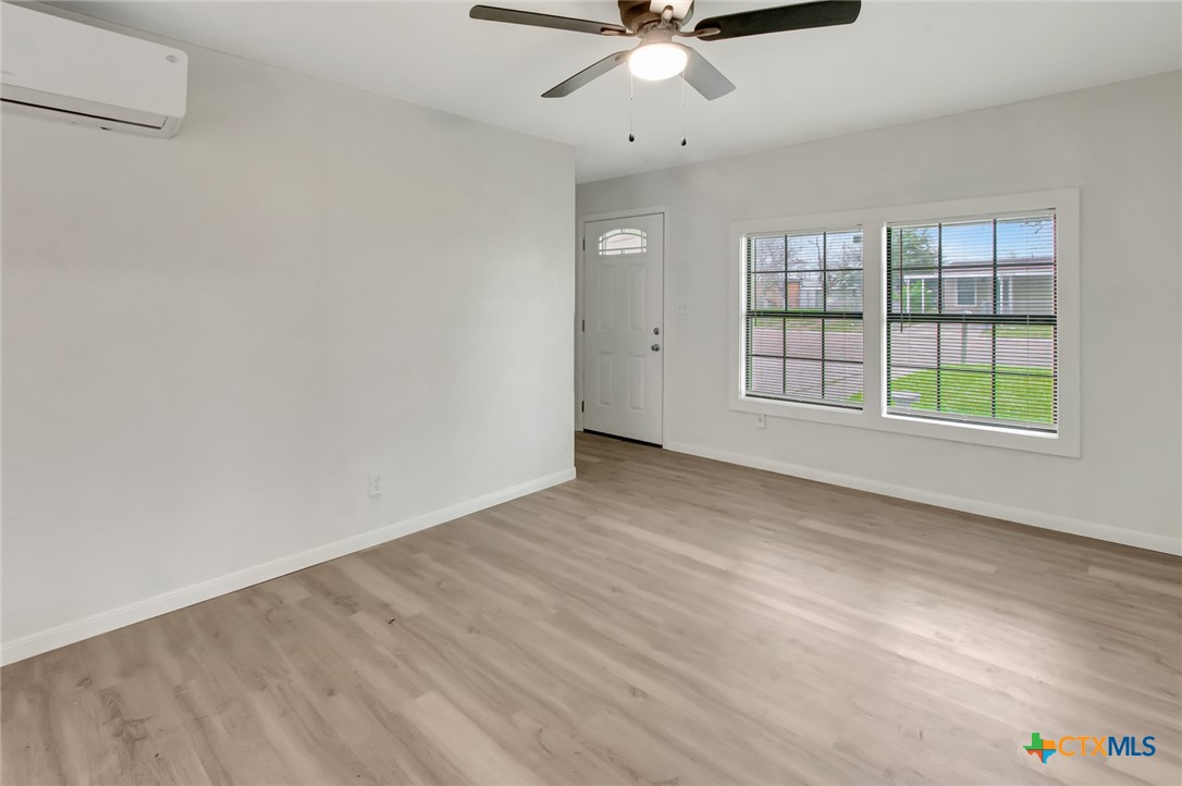 2907 Cedar Street Victoria, TX 77901 - Photo 4 of 45 an empty room with wooden floor fan and windows