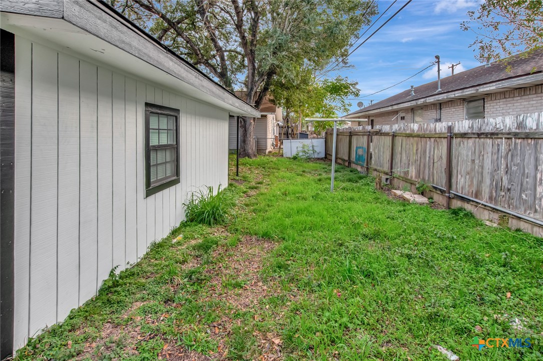 2907 Cedar Street Victoria, TX 77901 - Photo 41 of 45 a view of a backyard with large trees and wooden fence