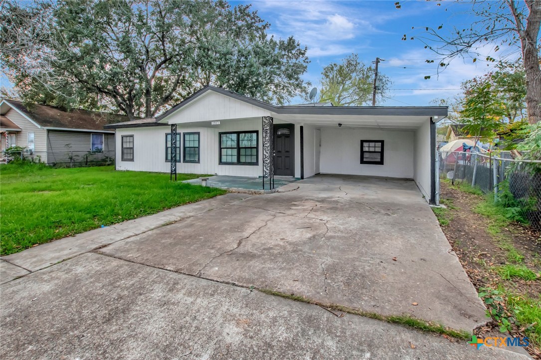 2907 Cedar Street Victoria, TX 77901 - Photo 42 of 45 a front view of a house with a garden and yard