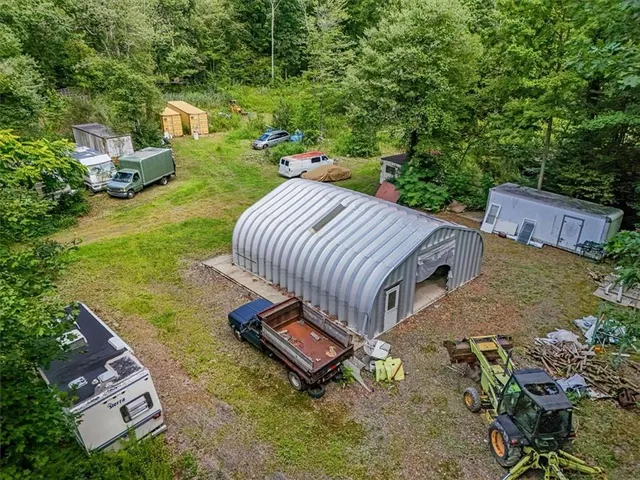 an aerial view of a house with garden space and street view
