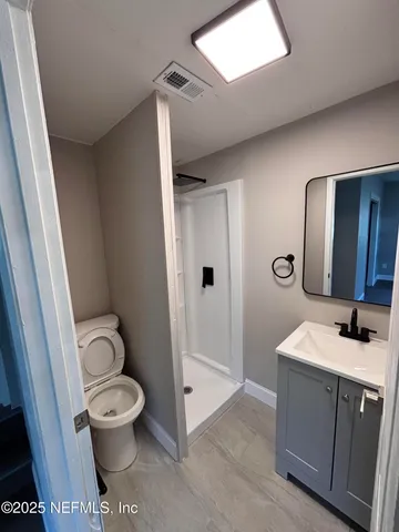 a bathroom with a toilet sink and shower