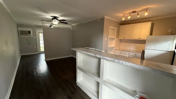 a view of a kitchen with a sink and dishwasher wooden floor