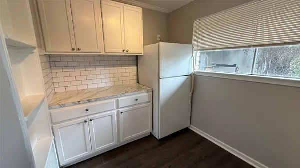 a kitchen with appliances cabinets and a window
