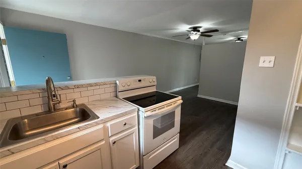 a kitchen with a stove and a sink