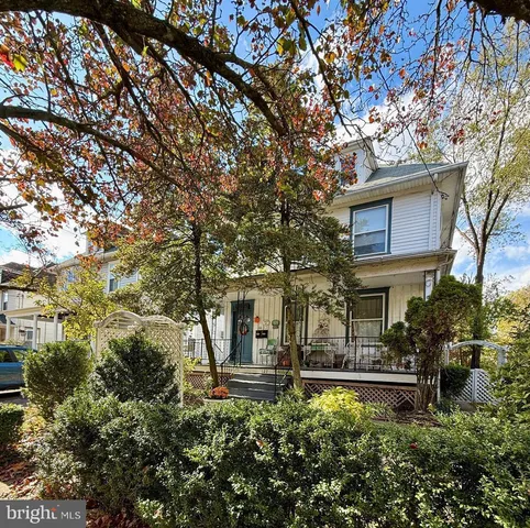 a view of a house with brick walls and a tree