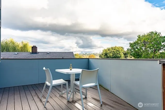 a balcony with table and chairs