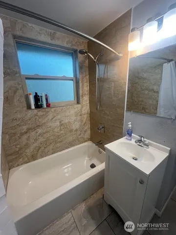 a bathroom with a bathtub and a sink