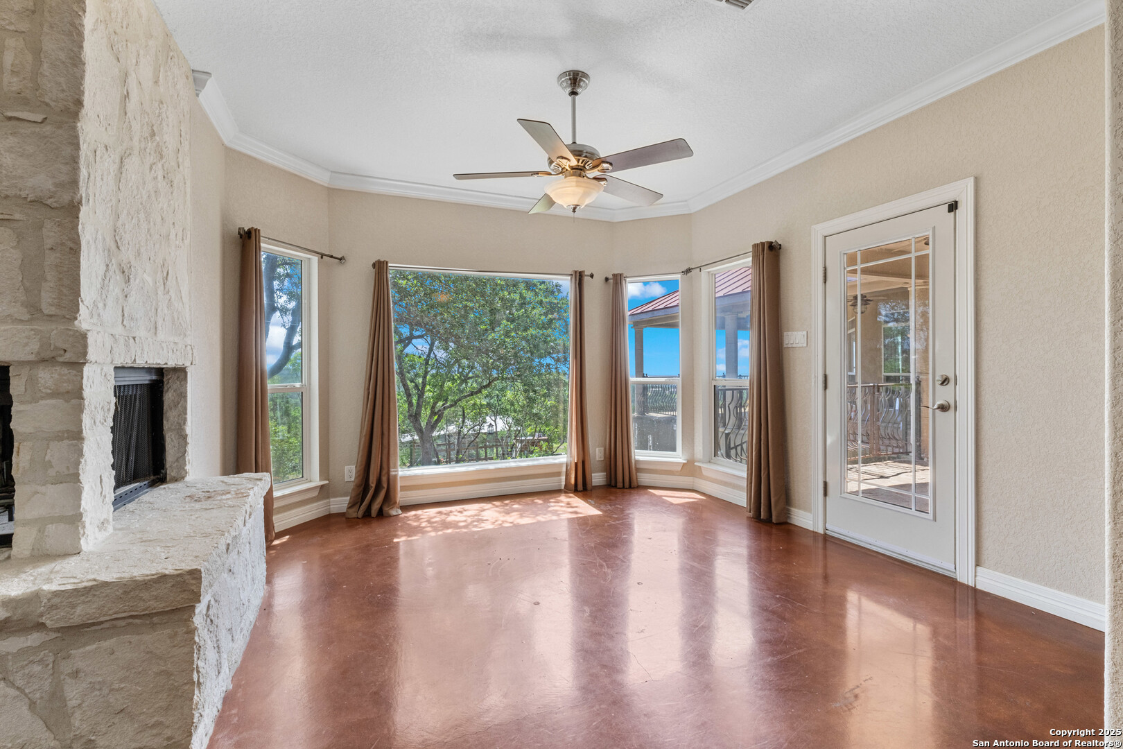 165 County Road 2740 Mico, TX 78056 - Photo 11 of 30 wooden floor fireplace and windows in an empty room