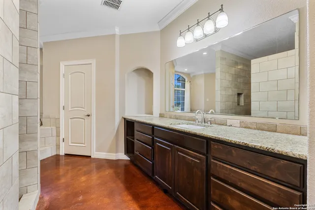 a bathroom with a sink a vanity and a mirror