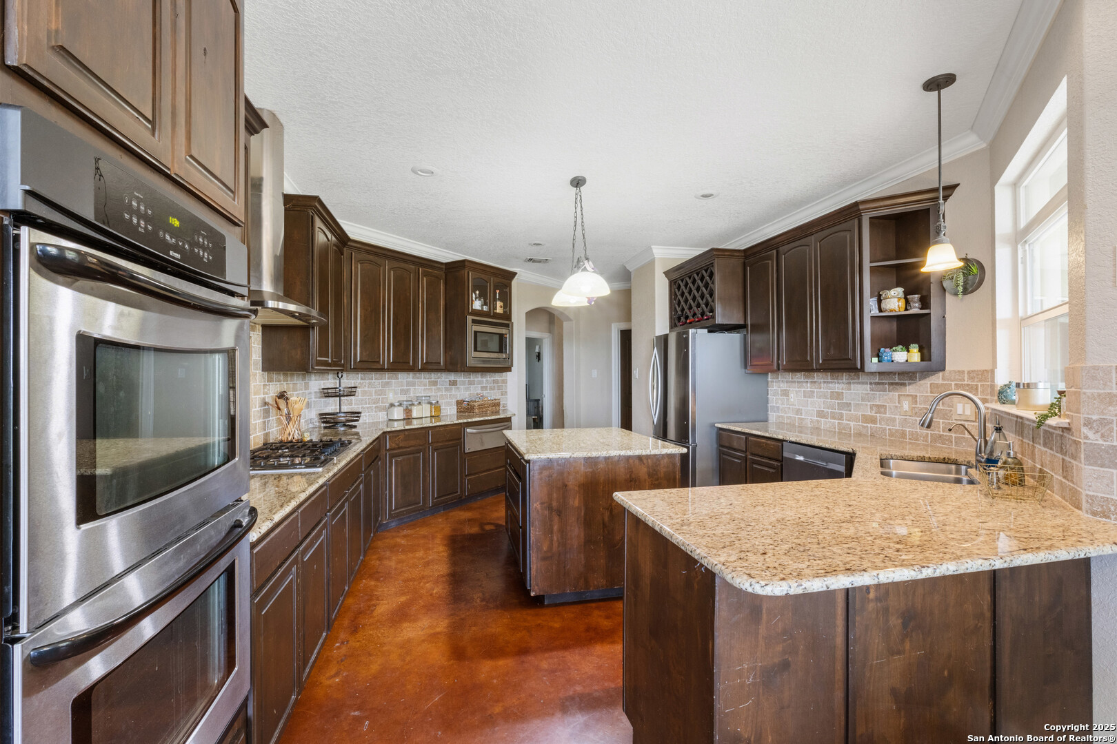 165 County Road 2740 Mico, TX 78056 - Photo 17 of 30 a kitchen with stainless steel appliances granite countertop a sink a stove and a refrigerator