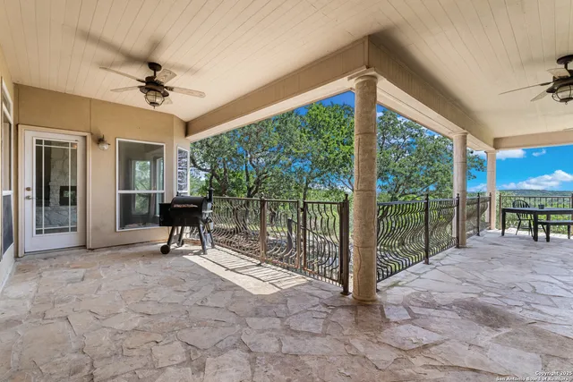 a view of a porch with furniture and a yard