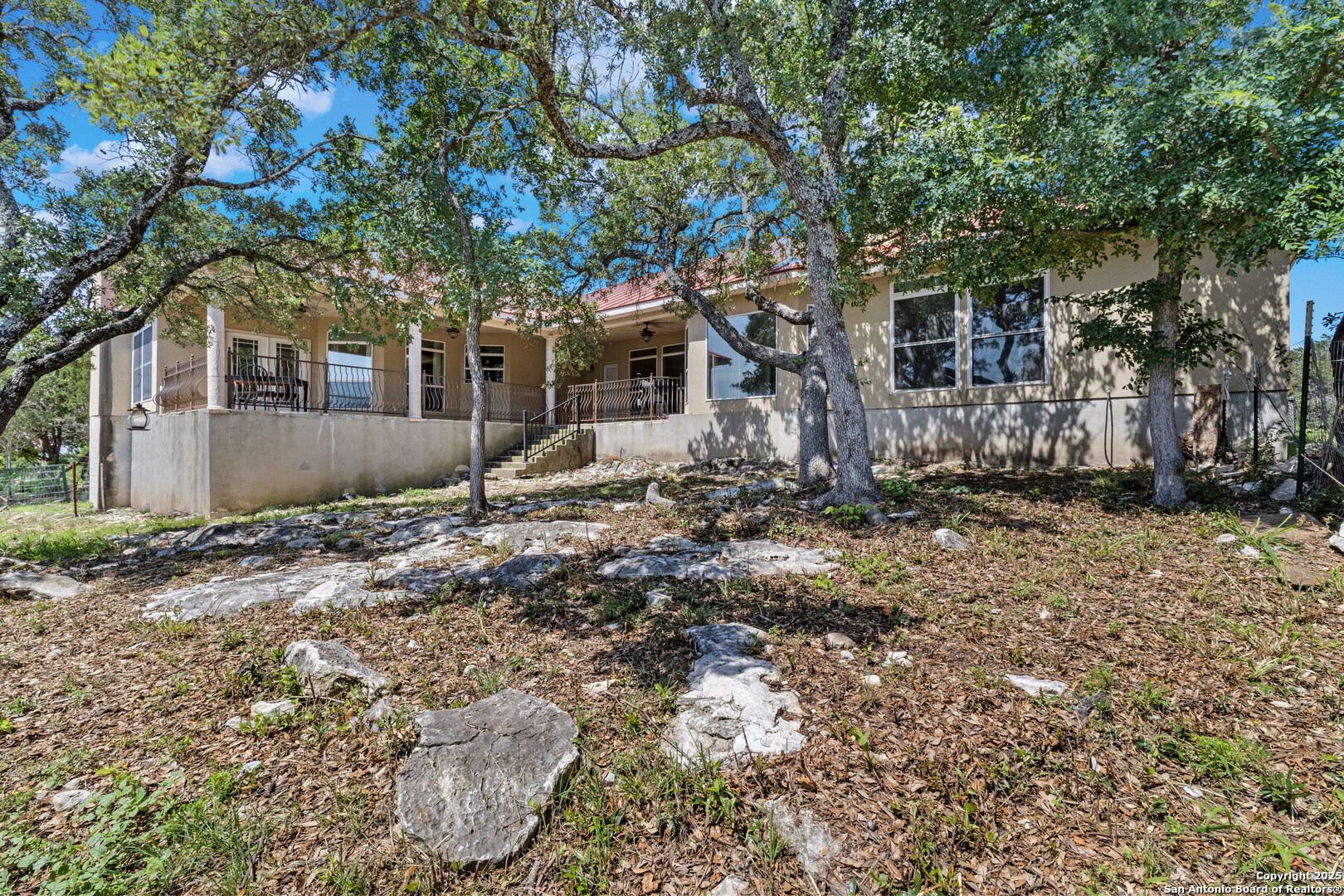 165 County Road 2740 Mico, TX 78056 - Photo 25 of 30 a tree in front of a white house
